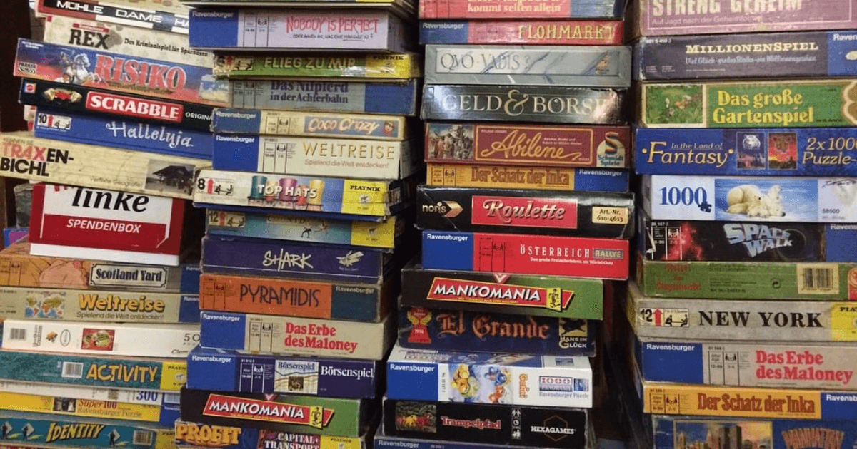 Board game collection on library shelf