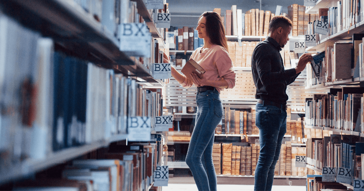 Two people browsing a library